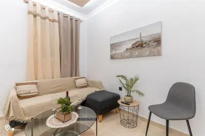 a living room with a couch and a glass table at Danae's - Luxury & Modern Apartment in Egaleo-Athens in Athens