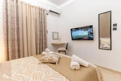 a bedroom with a bed and a tv on the wall at Danae's - Luxury & Modern Apartment in Egaleo-Athens in Athens