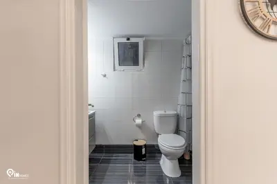a white bathroom with a toilet and a sink at Danae's - Luxury & Modern Apartment in Egaleo-Athens in Athens