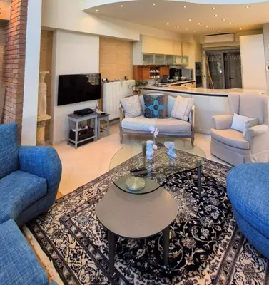 a living room with two couches and a coffee table at Modern Villa in the heart of Athens Riviera with garden in Athens