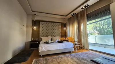 a bedroom with a bed and a large window at Modern Villa in the heart of Athens Riviera with garden in Athens