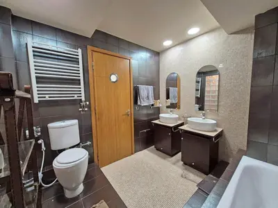 a bathroom with two sinks and a toilet at Modern Villa in the heart of Athens Riviera with garden in Athens