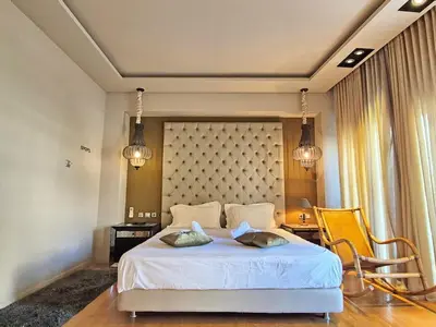 a bedroom with a large white bed with two pillows at Modern Villa in the heart of Athens Riviera with garden in Athens