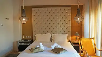 a bedroom with a large white bed with two pillows at Modern Villa in the heart of Athens Riviera with garden in Athens