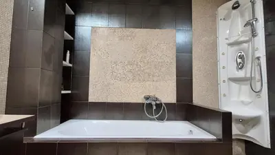 a bath tub in a bathroom with a shower at Modern Villa in the heart of Athens Riviera with garden in Athens