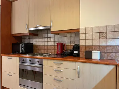 a kitchen with a stove and a microwave at Casa Nikos in Athens