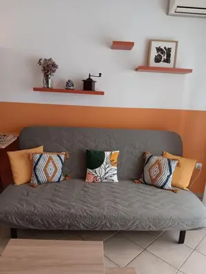 a couch with pillows on it in a living room at Casa Nikos in Athens