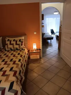 a bedroom with a bed and a table with a lamp at Casa Nikos in Athens
