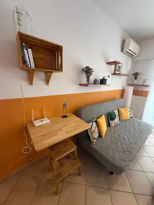 a living room with a couch and a wooden table at Casa Nikos in Athens