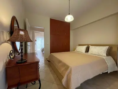 a bedroom with a bed and a table with a lamp at Casa Nikos in Athens