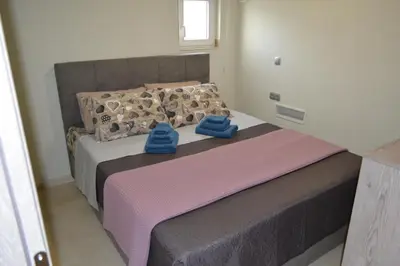 a bedroom with a bed with blue towels on it at Stergiou Luxury Apartments με κοινη πισινα in Saronida