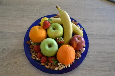 a blue plate of fruits and vegetables on a table at Stergiou Luxury Apartments με κοινη πισινα in Saronida