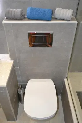 a bathroom with a white toilet in a stall at Stergiou Luxury Apartments με κοινη πισινα in Saronida