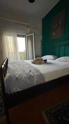 a bedroom with a bed with a teddy bear on it at Themis Apartment in Athens - Court Area in Athens