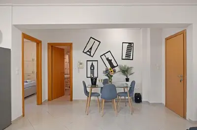 a dining room with a table and chairs at Βίλα Λαγονήσι in Kalívia Thorikoú