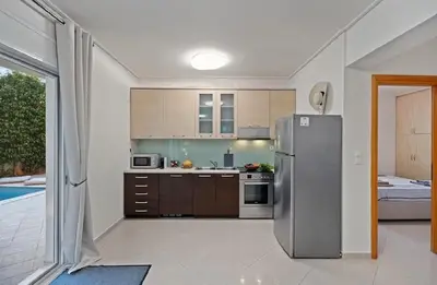 a kitchen with a stainless steel refrigerator in a house at Βίλα Λαγονήσι in Kalívia Thorikoú