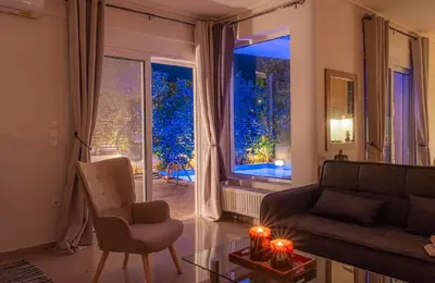 a living room with a couch and a large window at Βίλα Λαγονήσι in Kalívia Thorikoú