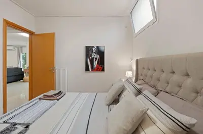 a bedroom with a large bed and a window at Βίλα Λαγονήσι in Kalívia Thorikoú