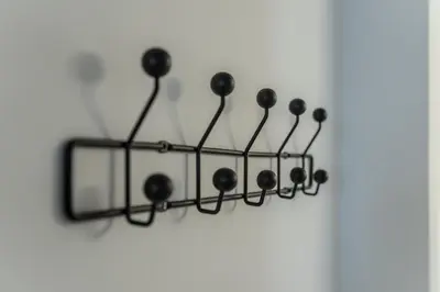 a group of black hooks hanging on a wall at Asclepius apartment Athens Airport in Spáta