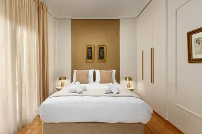 a bedroom with a large white bed with two towels at The Athenian Aroma - 3BDRM Exclusive Residence in Athens