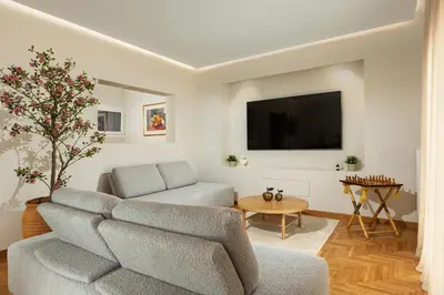 a living room with a couch and a tv at The Athenian Aroma - 3BDRM Exclusive Residence in Athens