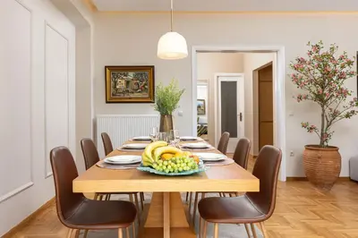 a dining room table with a bowl of fruit on it at The Athenian Aroma - 3BDRM Exclusive Residence in Athens