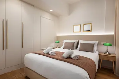 a bedroom with a large bed with two pillows at The Athenian Aroma - 3BDRM Exclusive Residence in Athens