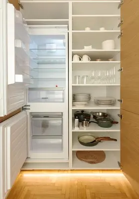 a white refrigerator with its door open with dishes at The Athenian Aroma - 3BDRM Exclusive Residence in Athens