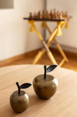two small metal objects sitting on a table with a chessboard at The Athenian Aroma - 3BDRM Exclusive Residence in Athens