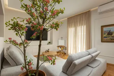 a living room with a couch and a tree at The Athenian Aroma - 3BDRM Exclusive Residence in Athens