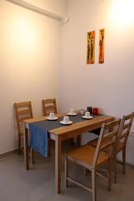 a dining room with a table and four chairs at Sea & garden view cozy apartment with good privacy in Athens