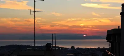a view of the sunset from a city at Sea & garden view cozy apartment with good privacy in Athens