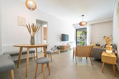a living room with a table and chairs at Seaview Balcony in Varkiza by ΜΡS in Vari