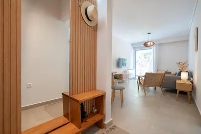 a living room with a couch and a table at Seaview Balcony in Varkiza by ΜΡS in Vari