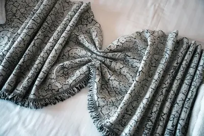 a black and white blanket on a bed at City Chic Living-3BR Kallirrois in Athens