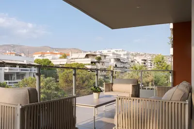 a balcony with chairs and a table with a view at Glyfada Golden Stay in Athens
