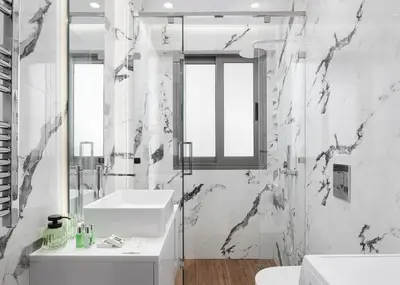 a white bathroom with a sink and a mirror at Glyfada Golden Stay in Athens