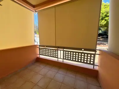an empty room with a window and a tiled floor at Anavyssos Azure in Anavissos