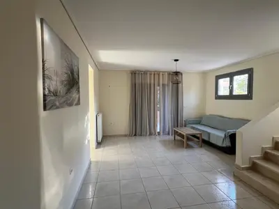 a living room with a bed and a couch at Anavyssos Azure in Anavissos