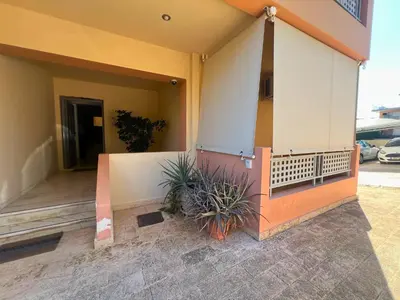 a front porch of a building with plants on it at Anavyssos Azure in Anavissos