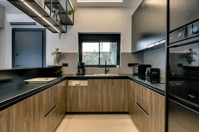 a kitchen with wooden cabinets and a sink at Casa Aura-Artistic Living Faliro in Athens