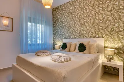 a bedroom with a bed with two pillows on it at Casa Aura-Artistic Living Faliro in Athens