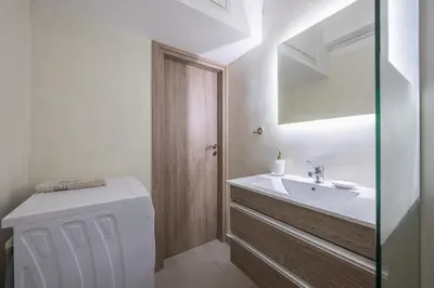 a bathroom with a sink and a toilet and a mirror at Ground floor apartment, 100m from metro Panormou in Athens