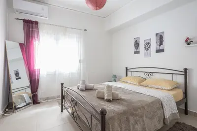 a bedroom with a bed and a window at Ground floor apartment, 100m from metro Panormou in Athens