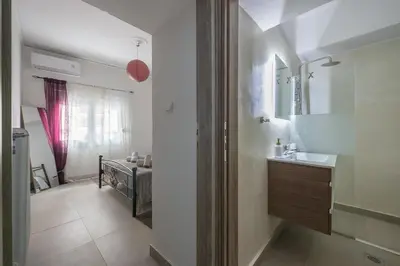 a bathroom with a sink and a mirror at Ground floor apartment, 100m from metro Panormou in Athens