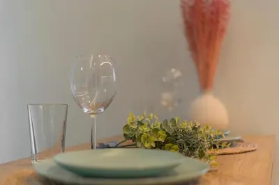 a table with a plate and a wine glass at Highway Haven - Halandri in Athens