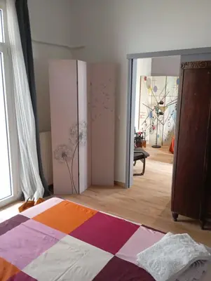 a bedroom with a colorful bed and a mirror at Lemon tree's House in Athens in Athens