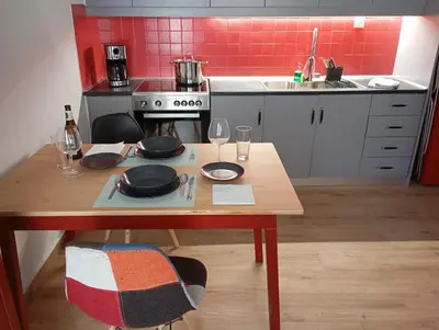 a kitchen with a wooden table with plates and wine glasses at Lemon tree's House in Athens in Athens
