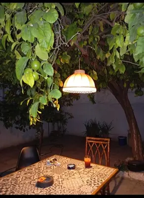 a table with a light hanging from a tree at Lemon tree's House in Athens in Athens