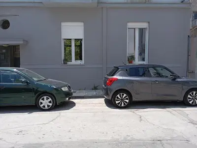 two cars parked in front of a house at Lemon tree's House in Athens in Athens